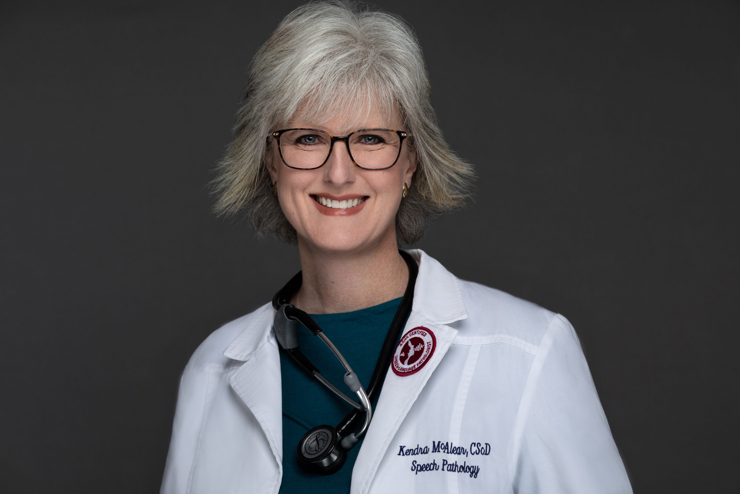 Kendra McAlear in a lab coat - headshot